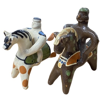 Lot 428 - Two pottery models of riders on horseback, on...