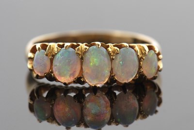 Lot 386 - A five stone opal ring, the five slightly...