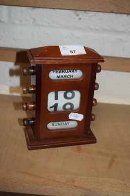 Lot 87 - Small wooden cased perpetual desk calendar,...