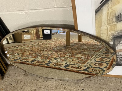 Lot 248 - An oval bevelled wall mirror