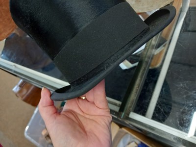 Lot 147 - A black silk top hat by Henry Heath Ltd.,...