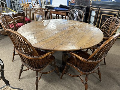 Lot 599 - A large 20th Century oak circular top dining...