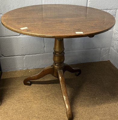 Lot 605 - A Georgian oak supper table with circular top...