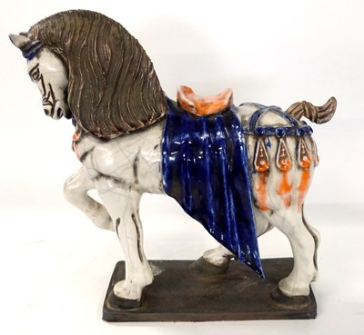 Lot 282 - A large ceramic model of a prancing horse on...