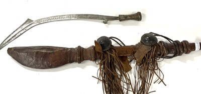 Lot 285 - A tribal sword together with a further example...