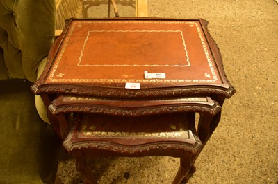 Lot 386 - NEST OF THREE LEATHER TOPPED TABLES, LARGEST...