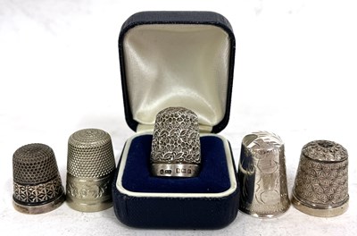 Lot 133 - A group of five thimbles to include two...