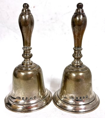 Lot 291 - Pair of George V silver table bells engraved...