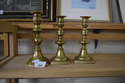 Lot 560 - THREE BRASS CANDLESTICKS