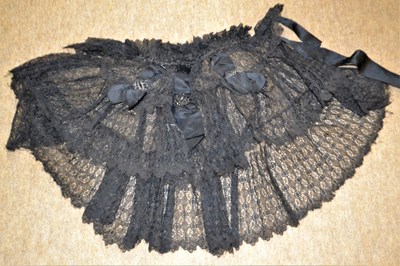 Lot 6 - A Victorian black lace shawl, the three tiered...