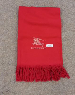 Lot 84 - A red cashmere scarf by Burberry, with gold...