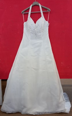 Lot 61 - A cream satin halterneck wedding gown, with...