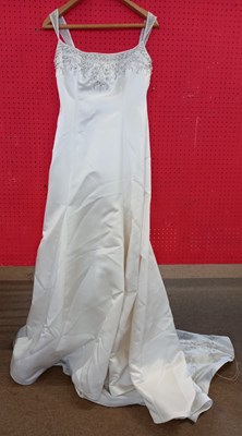 Lot 63 - A cream satin wedding gown, with beaded...