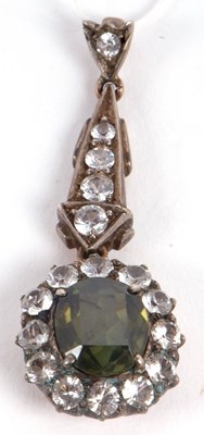 Lot 130 - A green and white stone pendant, the oval...