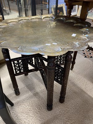 Lot 604 - Large Benares brass tray top table on folding...