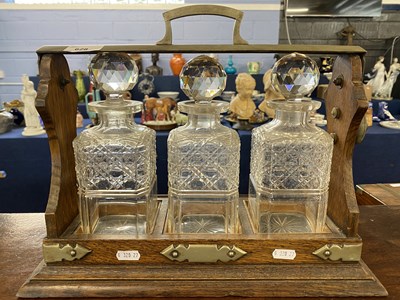 Lot 628 - Oak and silver plate mounted three bottle...