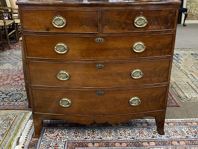 Lot 661 - Late Georgian mahogany bow front chest of two...