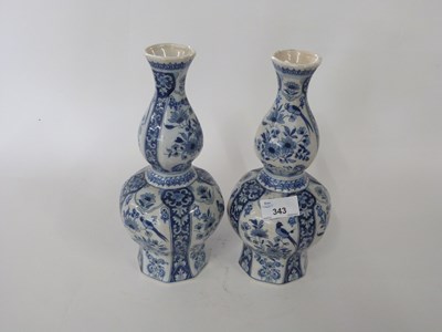 Lot 343 - A pair of Dutch Delft vases of faceted form...