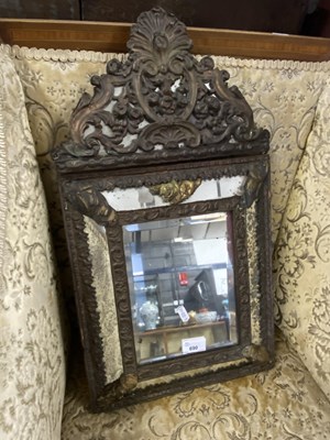 Lot 690 - Continental cushion formed mirror with central...