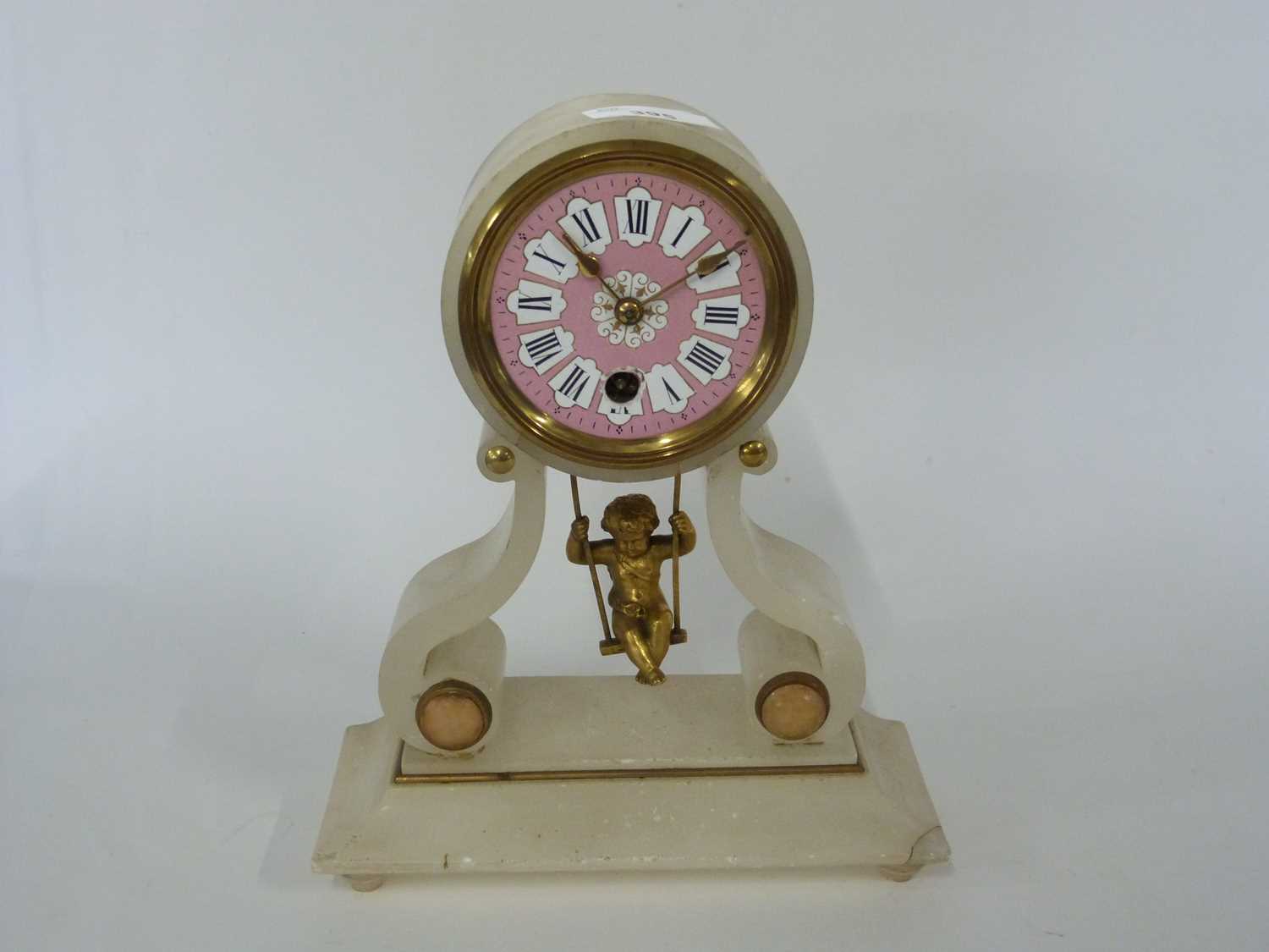 Lot 395 - A French style alabaster clock with a pink...
