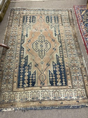 Lot 702 - An antique Middle Eastern wool floor rug...