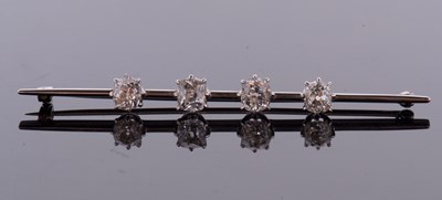 Lot 382 - A four stone diamond bar brooch, the four old...