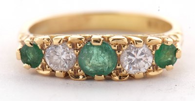 Lot 11 - An 18ct emerald and diamond ring, set with...