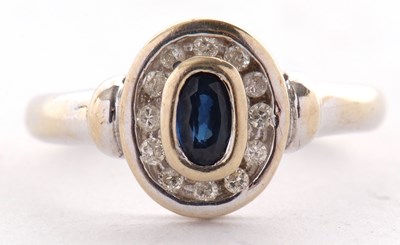 Lot 48 - An 18ct sapphire and diamond ring, the collet...