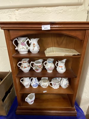 Lot 673 - A wooden display rack together with a quantity...