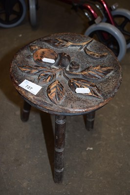 Lot 727 - Small three legged stool with carved floral...