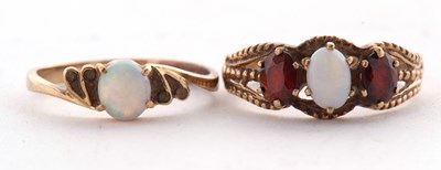 Lot 70 - A 9ct opal and garnet ring, the oval opal...