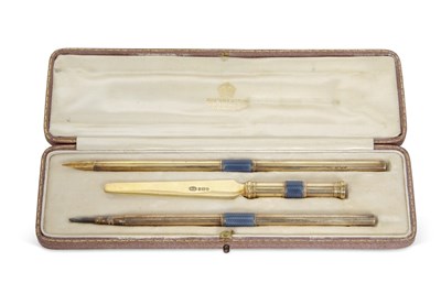 Lot 276 - A George V silver gilt and enamel desk pen set...