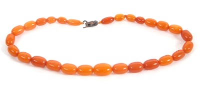 Lot 161 - An amber bead necklace, the oval amber beads,...