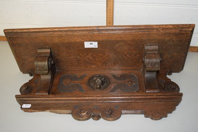 Lot 36 - A wooden wall shelf with lion mask decoration