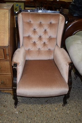 Lot 352 - Wing back armchair with pink button back...