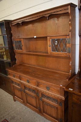 Lot 384 - Reproduction stained pine dresser with shelves,...