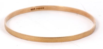 Lot 131 - A 9ct upper arm gold bangle, the 4.5mm wide...