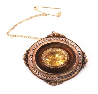 Lot 95 - A Victorian citrine brooch, the oval brooch...