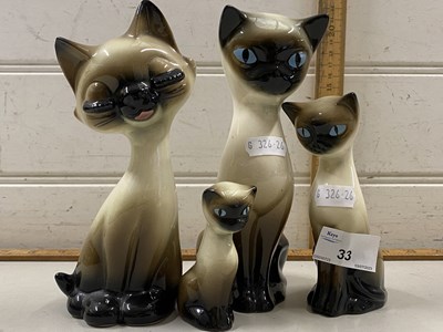 Lot 33 - Four  various pottery cats