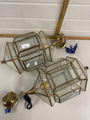 Lot 112 - A pair of brass mounted clear glass lanterns