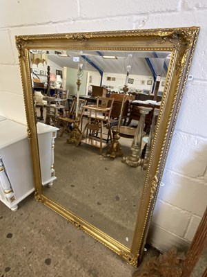 Lot 324 - Large rectangular bevelled wall mirror in gilt...