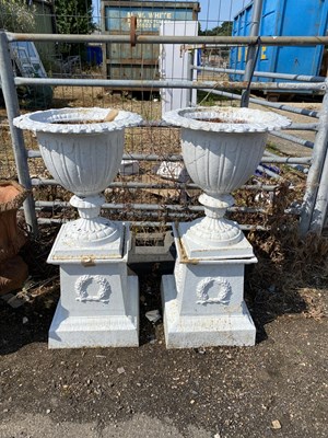 Lot 333 - Pair of cast iron urns and accompanying...