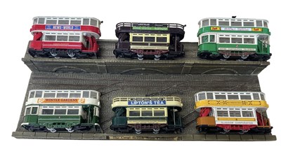 Lot 214 - A collection of die-cast Corgi tram models on...