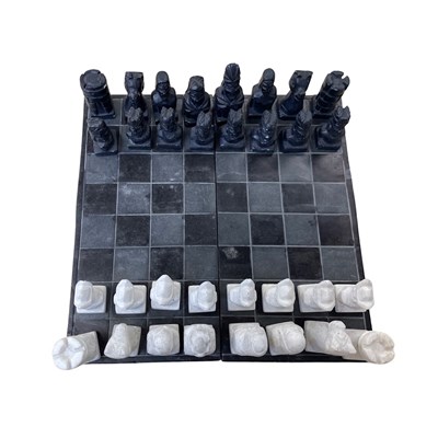 Lot 283 - A small slate and stone chess set.