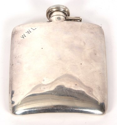 Lot 9 - A vintage white metal spirit flask of slightly...