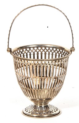 Lot 11 - A George V silver swing handled pierced basket...