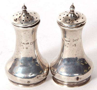 Lot 69 - A pair of George V silver peppers of plain...