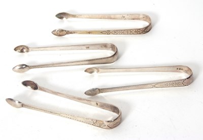 Lot 96 - Four pairs of Georgian silver sugar tongs each...