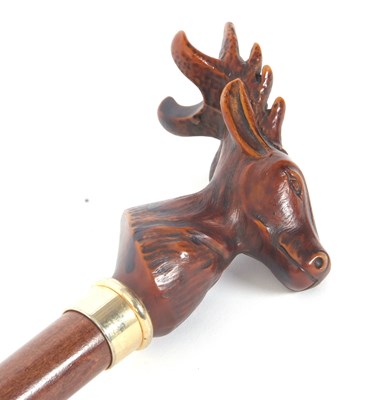 Lot 203 - A carved stags head walking stick, gilt metal...