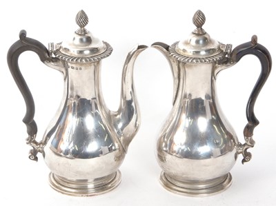 Lot 228 - A George V silver coffee pot and hot water jug...